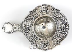 German Sterling silver tea strainer. Pierced and repousse Floral, Cherub, c1900
