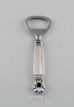 Two Georg Jensen Acorn bottle openers in sterling silver and stainless steel