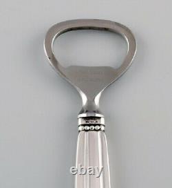 Two Georg Jensen Acorn bottle openers in sterling silver and stainless steel
